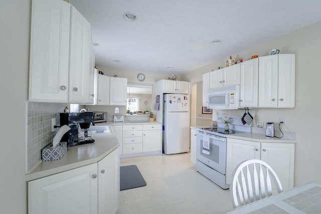 kitchen featuring white appliances and white cabinets