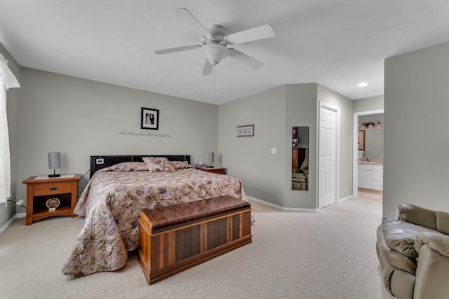 carpeted bedroom with connected bathroom and ceiling fan