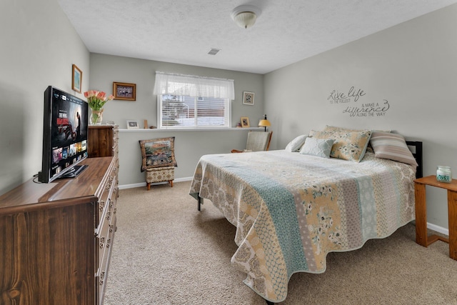 carpeted bedroom with a textured ceiling