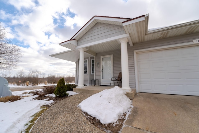 view of front of home featuring a porch and a garage