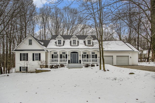 new england style home featuring a garage and a porch