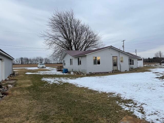 snow covered property featuring a yard