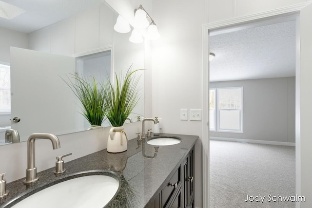 bathroom with vanity and a textured ceiling