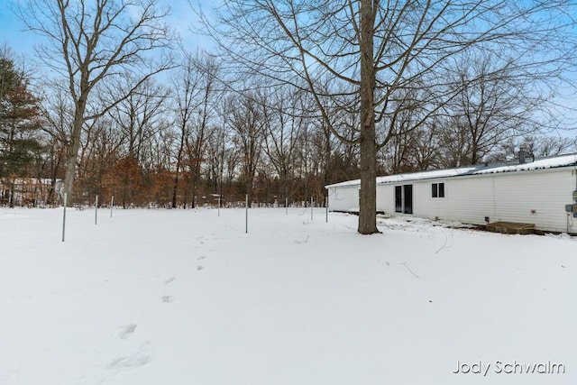 view of yard layered in snow