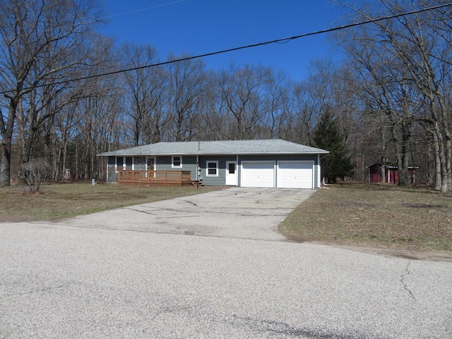606 Wall St, Eastlake, MI 49626 - ranch-style home featuring a garage, concrete driveway, and a front yard