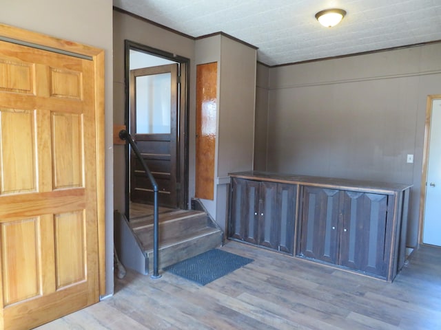 606 Wall St, Eastlake, MI 49626 - entrance foyer with wood finished floors, ornamental molding, and stairs
