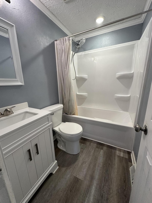 full bathroom with hardwood / wood-style flooring, vanity, a textured ceiling, toilet, and shower / bath combo with shower curtain