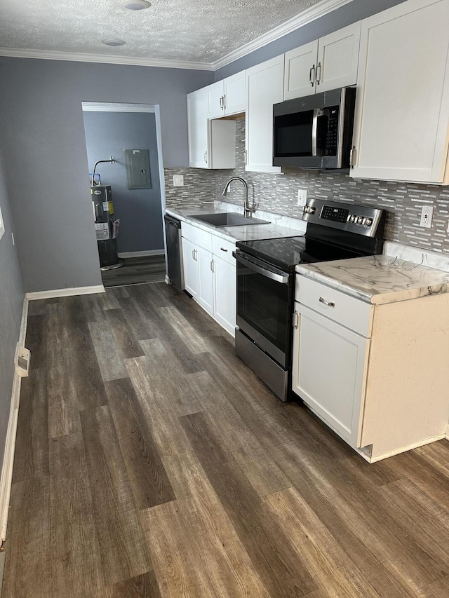 kitchen featuring sink, ornamental molding, white cabinets, and appliances with stainless steel finishes