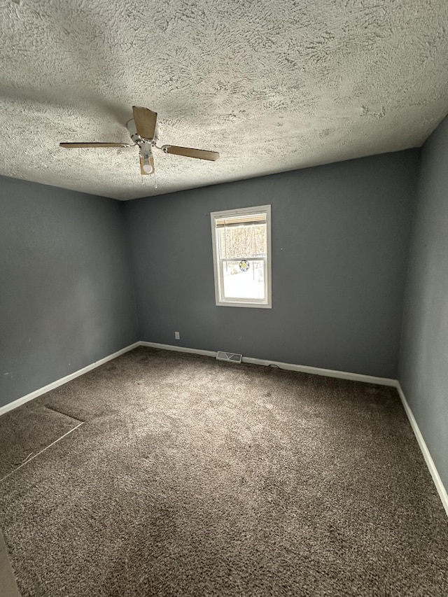 empty room featuring carpet flooring, a textured ceiling, and ceiling fan