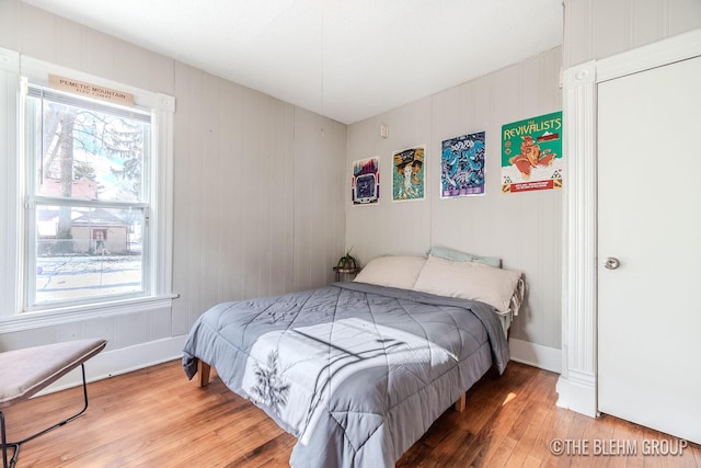 bedroom featuring multiple windows and hardwood / wood-style floors