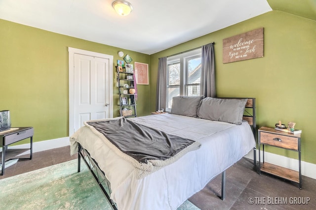 bedroom featuring lofted ceiling and a closet