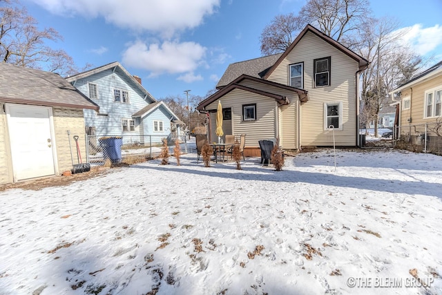 view of snow covered rear of property