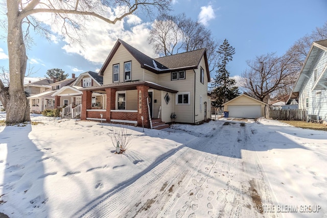 front of property with a garage and an outbuilding