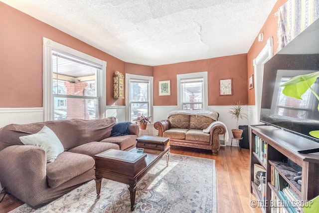 living room featuring hardwood / wood-style flooring and a textured ceiling