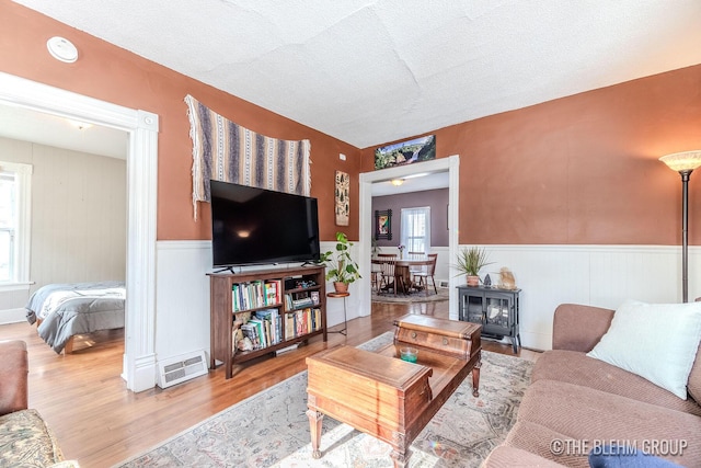 living room with light hardwood / wood-style flooring and a textured ceiling