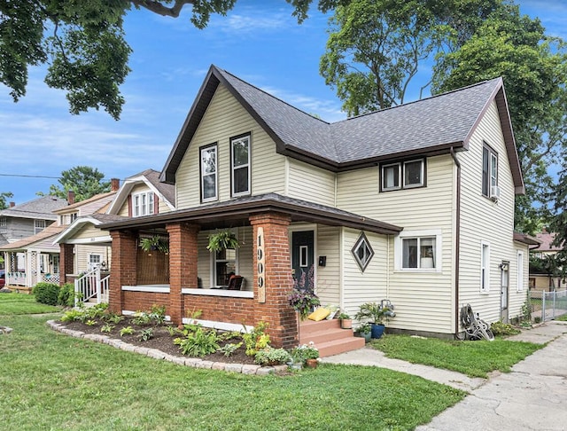 view of front facade with a front yard and a porch