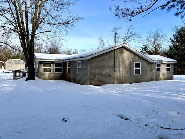 view of snow covered back of property