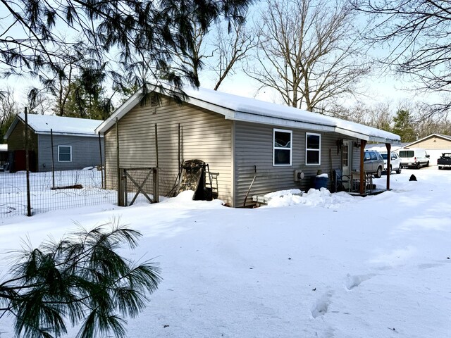 view of snow covered back of property