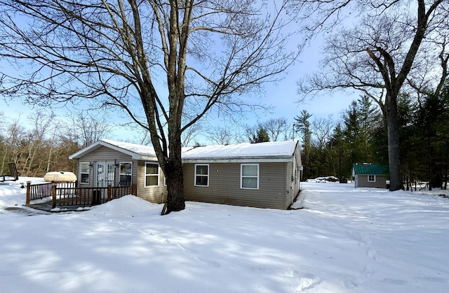 exterior space with a deck and a storage shed