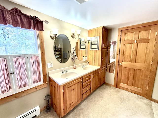 bathroom with vanity and a baseboard heating unit