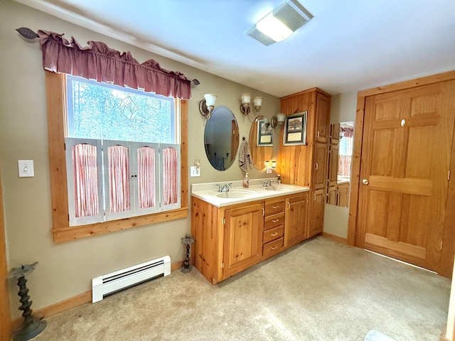 bathroom with baseboard heating and vanity