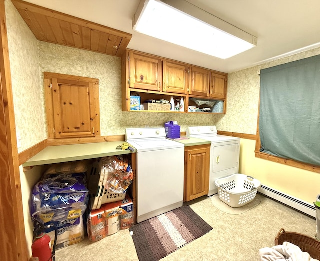 laundry room featuring independent washer and dryer, cabinets, and a baseboard heating unit