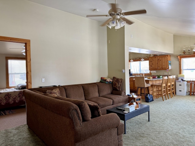 carpeted living room featuring high vaulted ceiling and ceiling fan