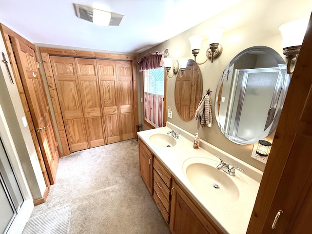 bathroom featuring vanity and an enclosed shower