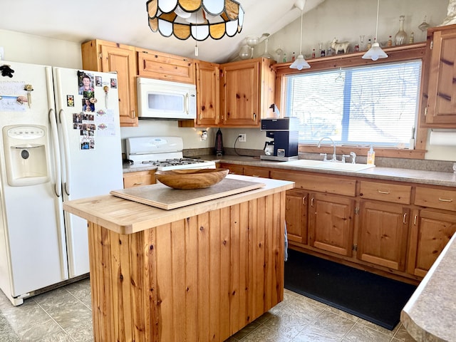 kitchen featuring lofted ceiling, sink, white appliances, and a center island