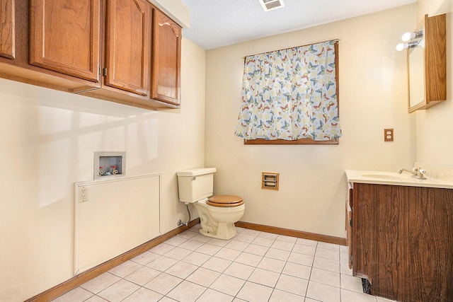 bathroom with tile patterned floors, vanity, and toilet