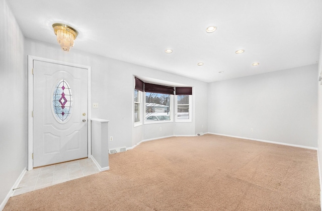 entryway with light colored carpet