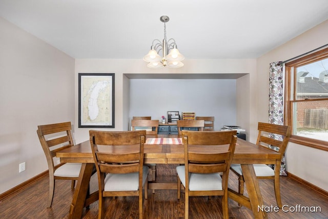 dining area featuring a notable chandelier and dark hardwood / wood-style flooring