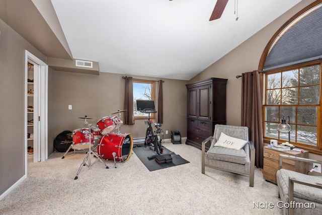 interior space featuring lofted ceiling, light carpet, and ceiling fan