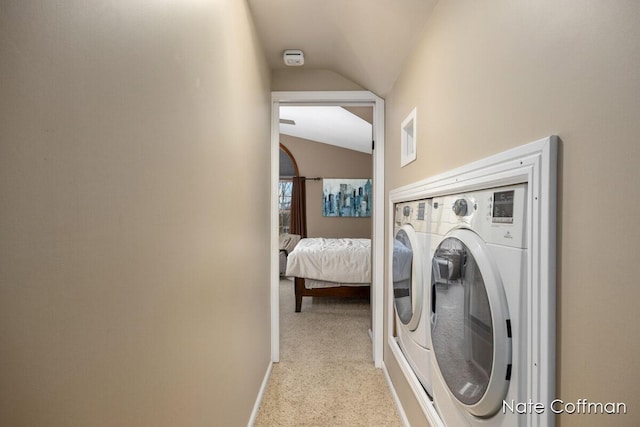 washroom featuring washing machine and dryer and light colored carpet