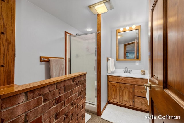 bathroom with vanity and a shower with door