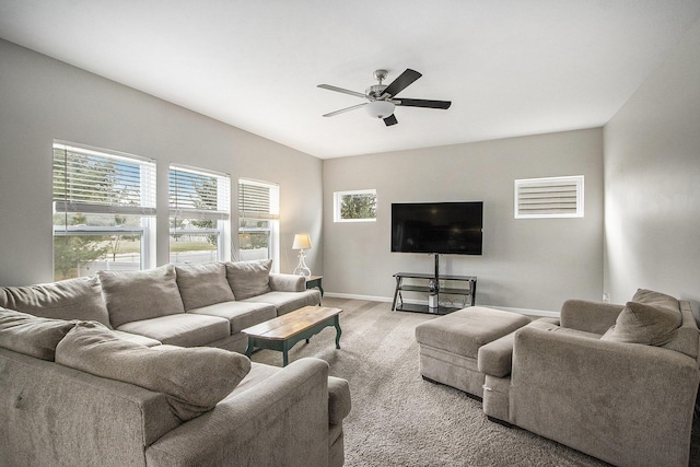 living room featuring a wealth of natural light, ceiling fan, and light wood-type flooring