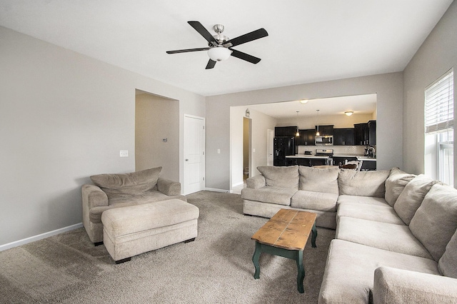 carpeted living room featuring ceiling fan