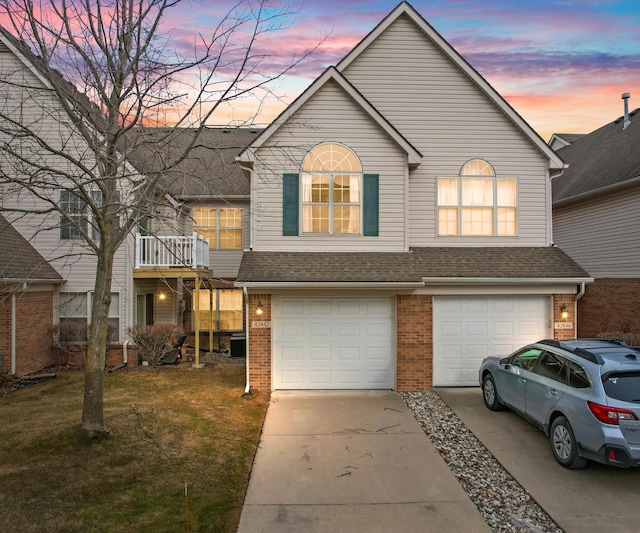 view of front of home featuring a garage and a yard