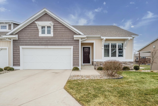 craftsman-style home with a garage and a front lawn