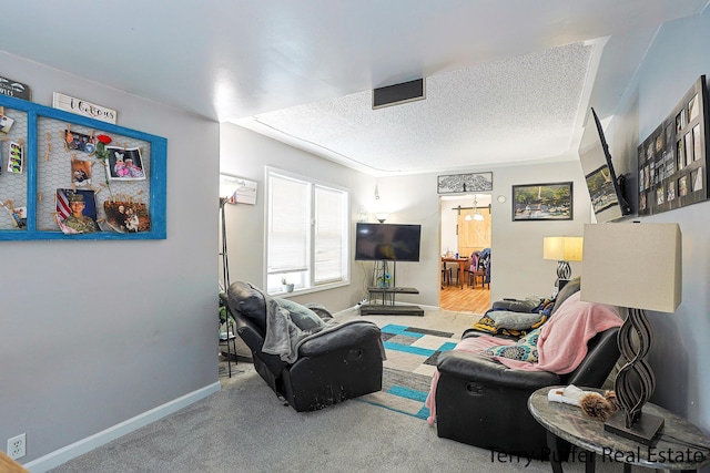 carpeted living area with a textured ceiling and baseboards