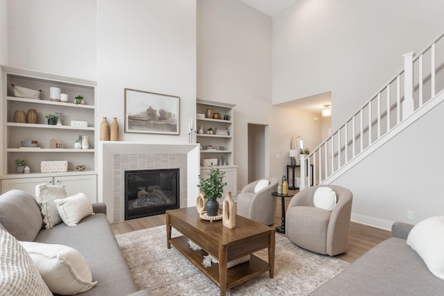 living room with light hardwood / wood-style flooring and a high ceiling