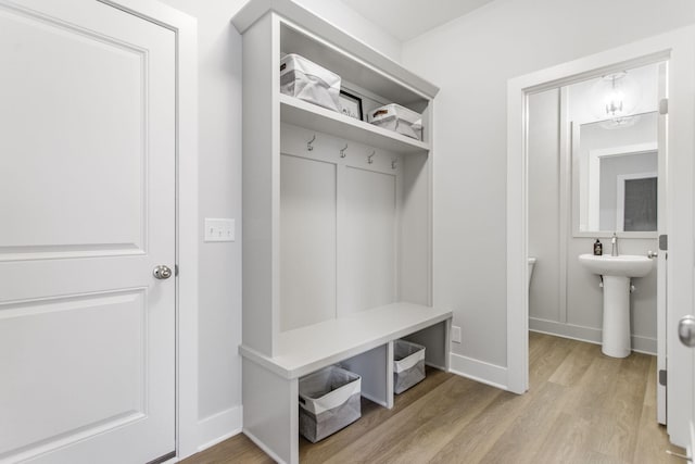 mudroom featuring sink and light hardwood / wood-style floors