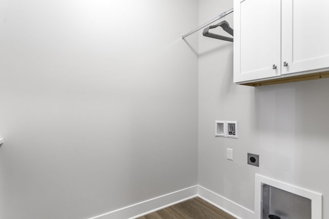 laundry area with electric dryer hookup, hookup for a washing machine, dark hardwood / wood-style flooring, and cabinets