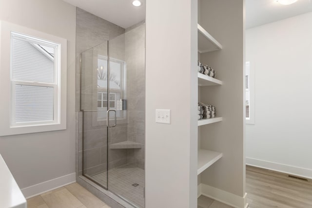 bathroom with a shower with door