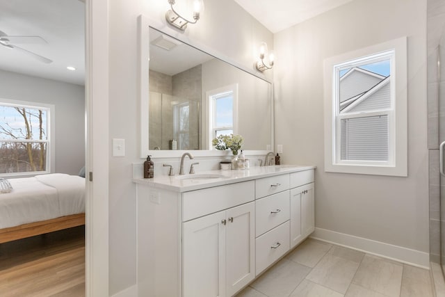 bathroom with vanity, a wealth of natural light, an enclosed shower, and ceiling fan