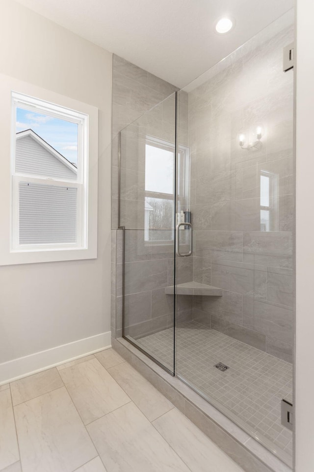 bathroom with a shower with shower door