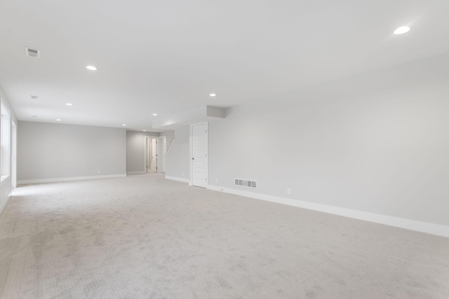 unfurnished room featuring light colored carpet