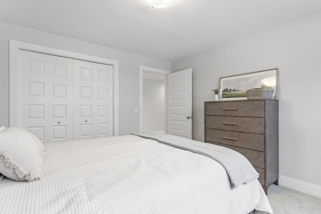 bedroom with light carpet and a closet