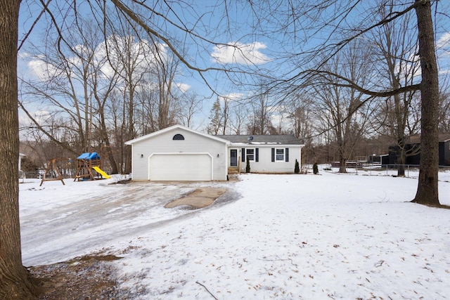 view of front of house with a garage and a playground