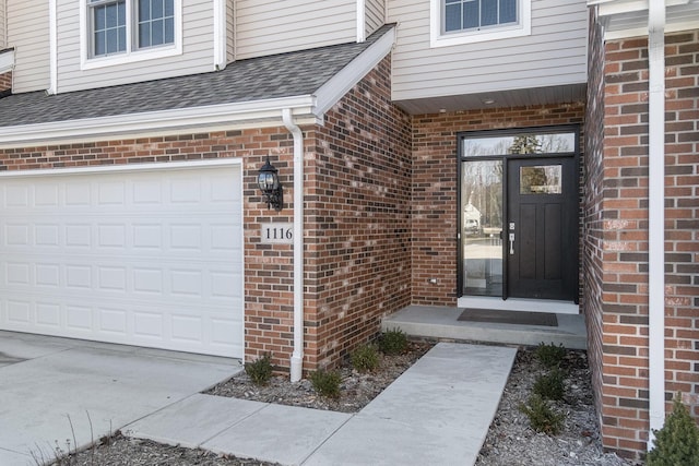 doorway to property with a garage